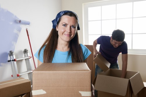 Professional packers preparing fragile household items for a move in Clapham