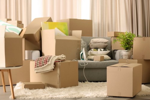 Movers carrying furniture through a Clapham property staircase